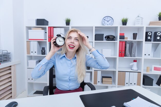 Office manager with alarm clock late to do the job