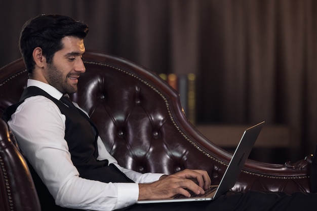 Office Manager Working On Computer At His Desk