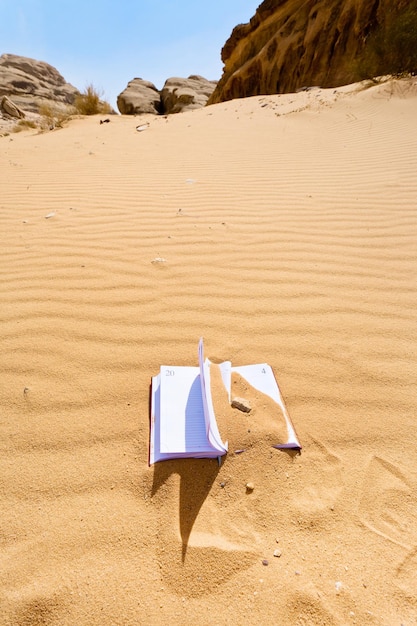 Office note book in red sand of desert