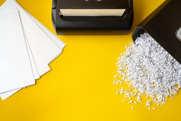 Photo office paper shredder on yellow studio background