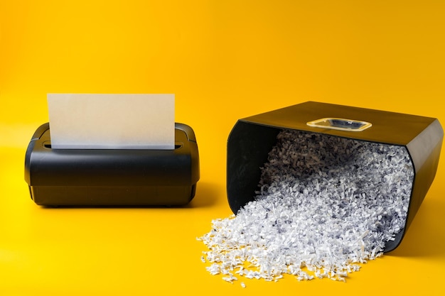 Photo office paper shredder on yellow studio background