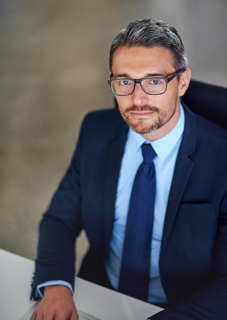 Office portrait and confident businessman at desk with opportunity trust and legal advice at law firm Lawyer attorney and mature man with professional pride about us and consultant at agency