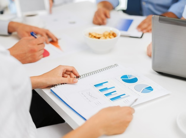 office, school and education concept - business team having discussion in office