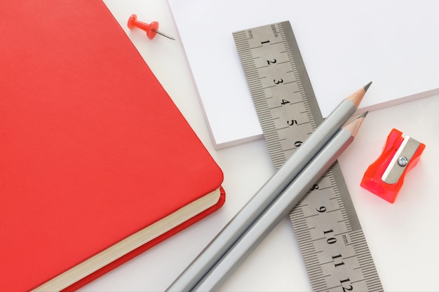 Photo office set with graphite pencils, ruler, notebook, paper and sharpener