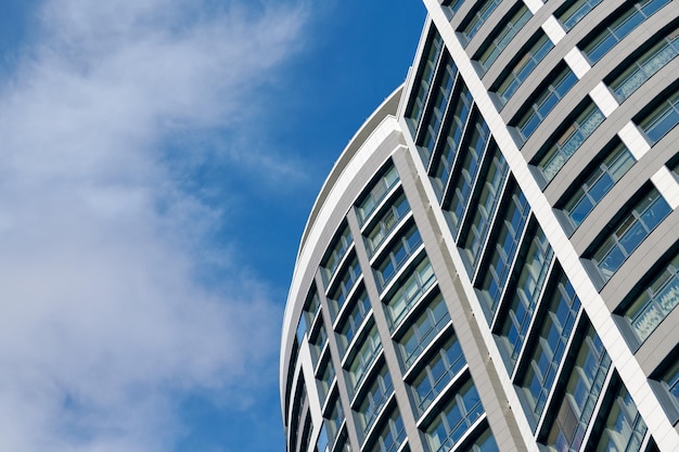 Office skyscraper high business building on blue sky background looking up to glass modern building