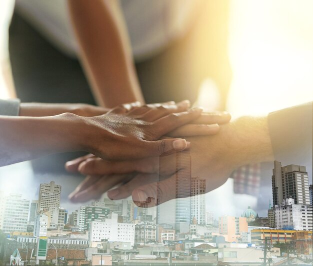 Office stack of hands and business people in unity collaboration and celebration for teamwork City overlay victory and corporate employees celebrating success or achievement together in workplace