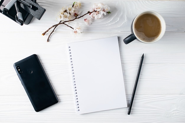 Office stationery, phone, notebook, coffee and pensil, writer overhead flat lay