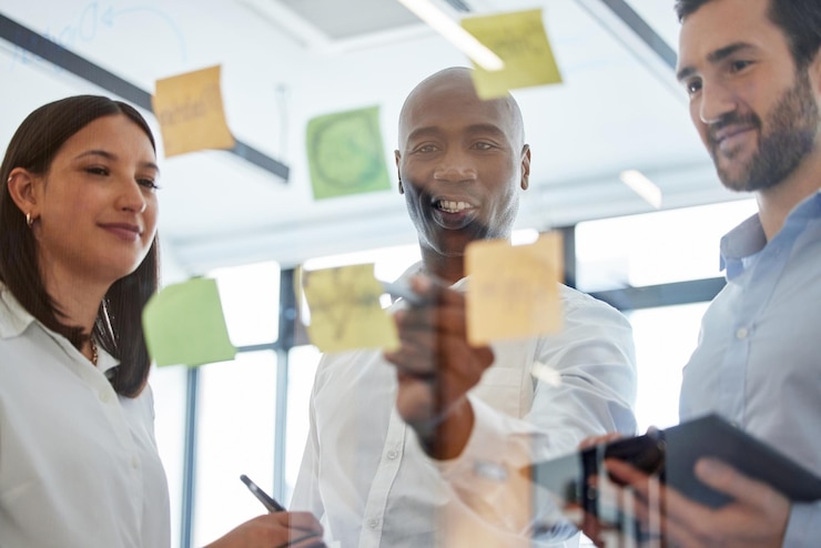Photo office sticky note and business people with meeting by window for sales planning review and feedback finance employees and team with discussion by glass for kpi analysis strategy and solution
