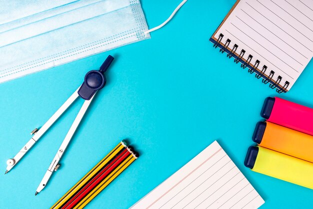 Office supplies on a blue background, with various office objects