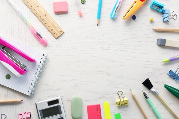 Office supplies on light wooden background