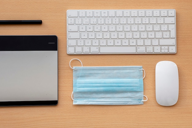 Office supplies and a protective mask on the desk