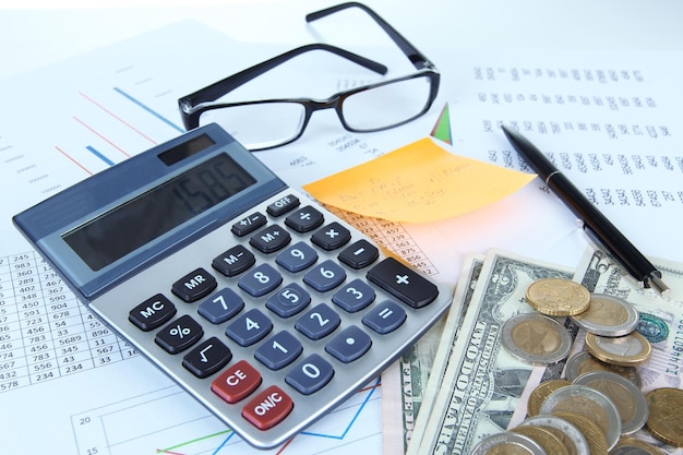 Photo office supplies with money and documents close up