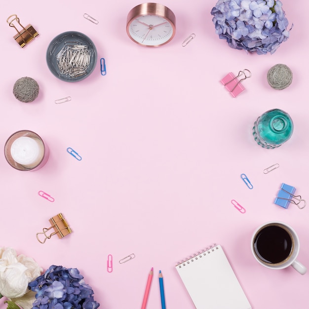 Office table desk. stationary on pink background. Flat lay. Top view.