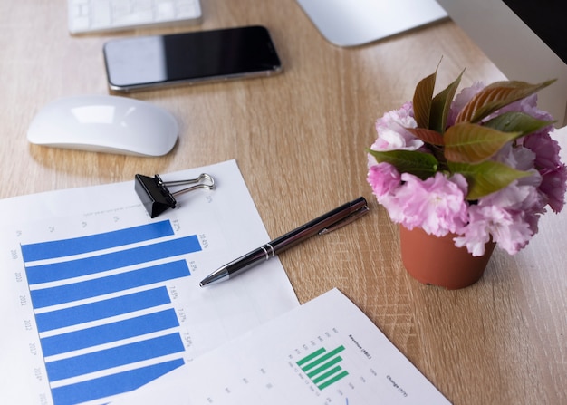 Office table, smart phone, pen and plant