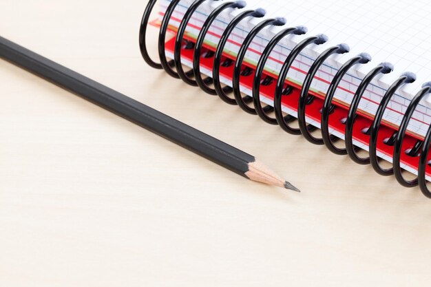 Office table with blank notepad and pencil