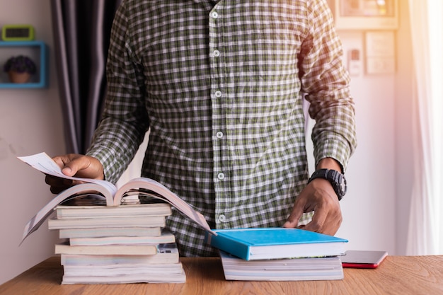 Office table with businessman open a book, reading a book.