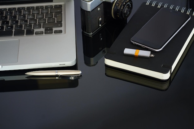 Office table with laptop phone and supplies