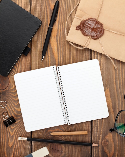 Office table with notepad vintage envelope and supplies