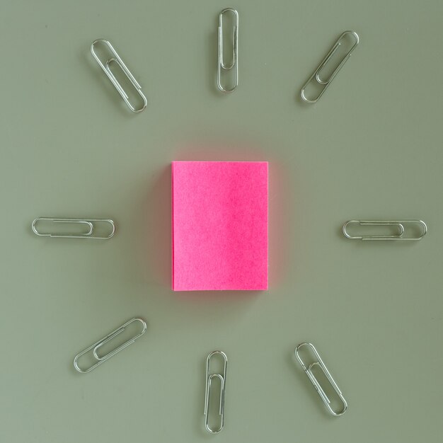 Office table with pink paper post it note