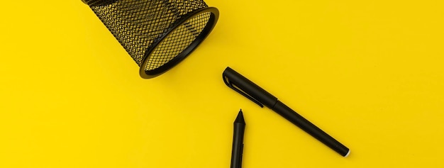 Office with pens on yellow background banner