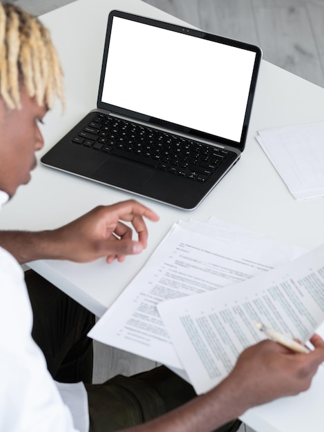 Office work concentrated man digital mockup unrecognizable black guy checking documents sitting desk