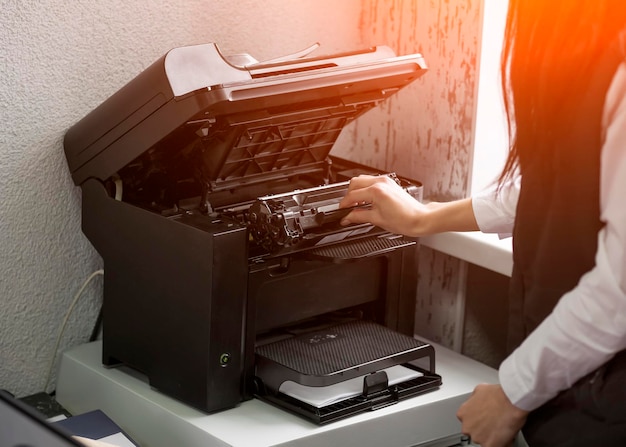 Office worker change the cartridge in a laser printer