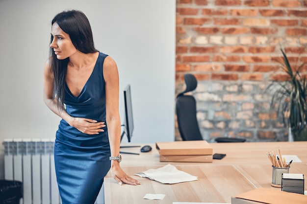 Office worker feeling discomfort in belly in the morning at the office