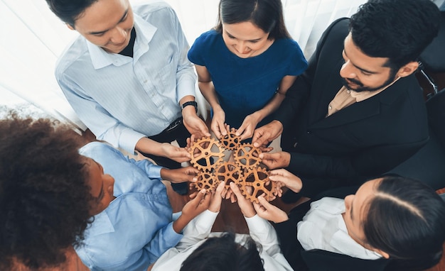 Photo office worker holding cog wheel as unity and teamwork in workplace concord