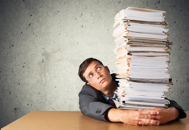 office worker holding paperwork stack