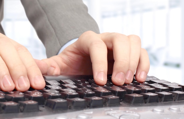 Office worker prints on the black keyboard