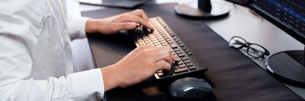 office worker sitting on workspace desk typing on keyboard trailblazing