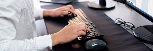 Photo office worker sitting on workspace desk typing on keyboard trailblazing