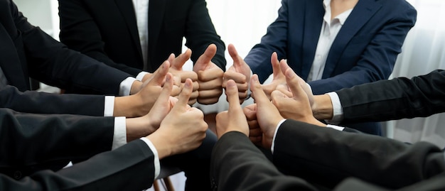 Office worker team stacking hand together symbolize successful group of business partnership and strong collective unity teamwork in community workplace in panoramic banner Shrewd