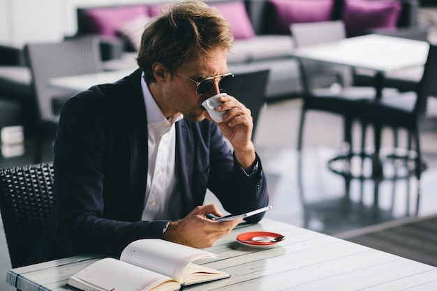 An Office Worker Went To A Restaurant To Drink Some Coffee And To Work Remotely