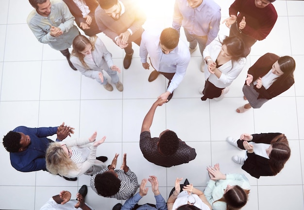 office workers and foreign employees stand and talk in the office lobbyTop view