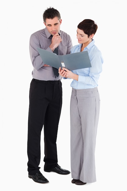 Office workers looking at a binder