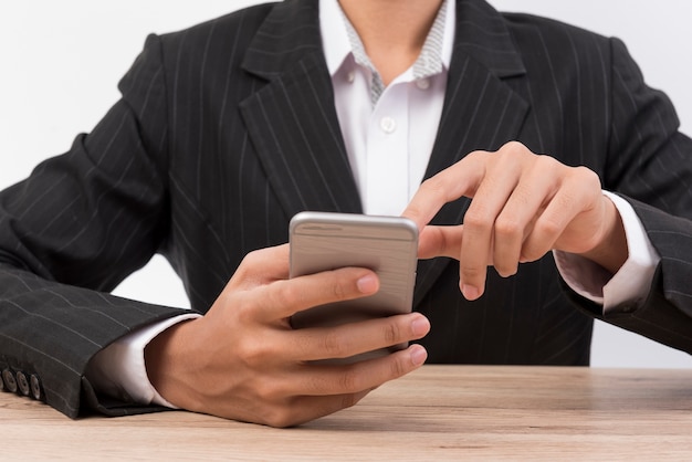 Office workers press the mobile phone on the desk.