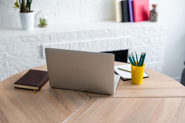 Office workplace with laptop and pencils on wood table