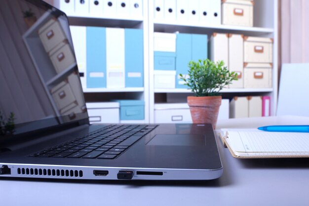 Office workplace with laptop and smart phone on wood table