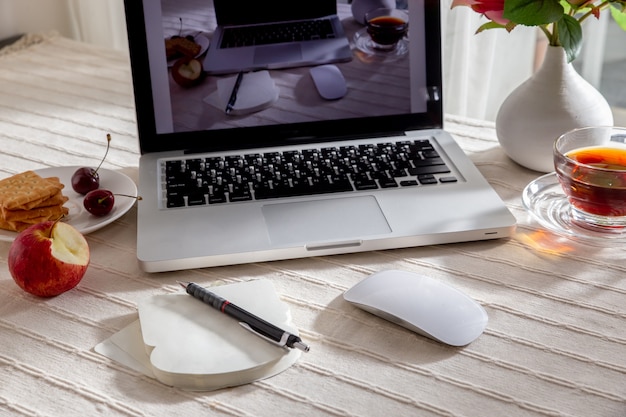 Office workplace with laptop and smartphone and tablet on wood table