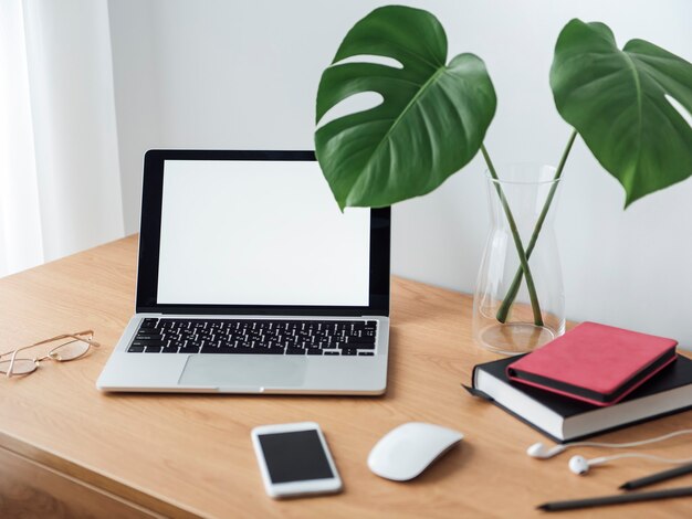 Office workplace with laptop on wooden table