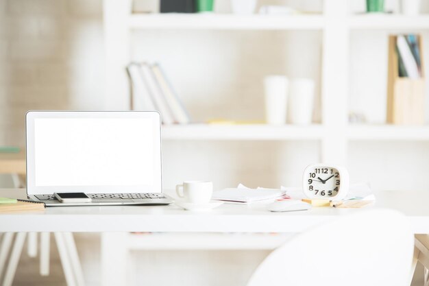 Office workplace with white laptop