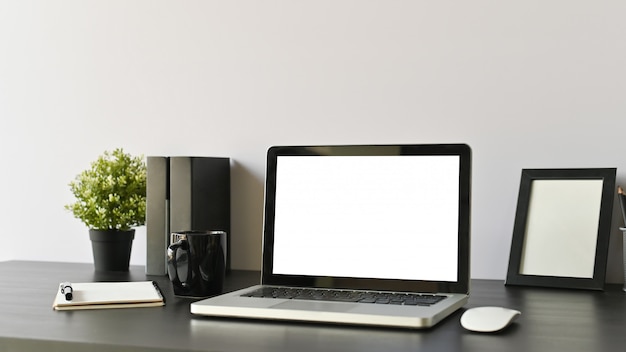 Office workspace computer, coffee and office supply on black table selective focus.