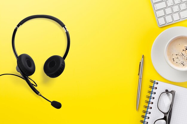 Office yellow backdrop with supplies and headset