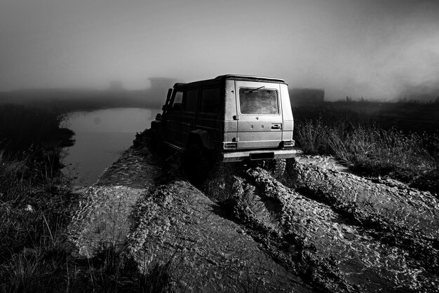 オフロードレーシングホイールの悪い道路の水のしぶきのオフロード車が田舎の風景ウィットにクローズアップ