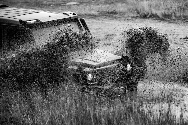 Offroad vehicle stuck on impenetrable road after rain in the countryside travel and racing concept f