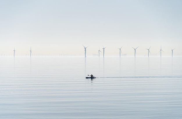 Photo offshore wind turbines generating renewable electricity and energy  atmospheric background image