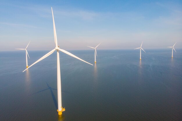 offshore windmill park with clouds and a blue sky