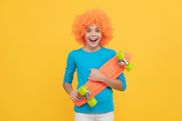 Oh my god fancy party look kid in clown wig hold penny board funny child with fancy hair teen girl wearing party glasses just having fun april fools day happy childhood activity going crazy