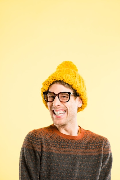 Oh stop, youre making me blush. Shot of a handsome young man standing alone in the studio and laughing.